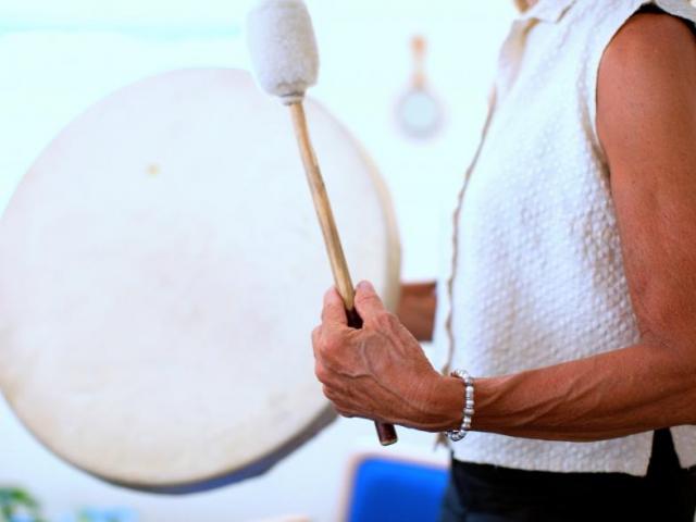 Image: woman with drum and mallet.